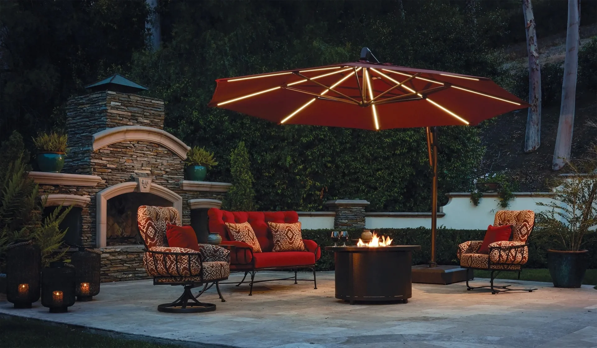 A patio with fire pit and red umbrella.