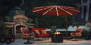 A patio with fire pit and umbrella.